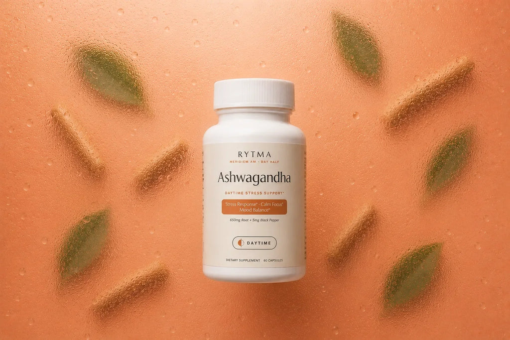 Rytma Ashwagandha bottle centred on a terracotta orange background behind water-beaded glass.